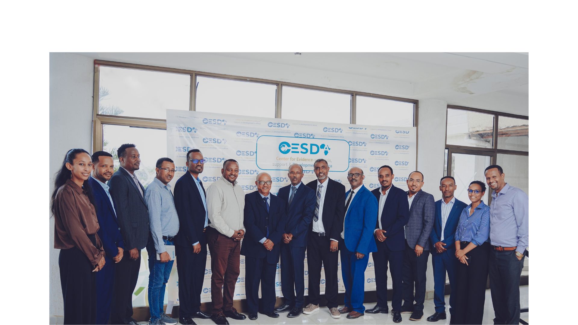 CESDA team photo in front of the CESDA banner