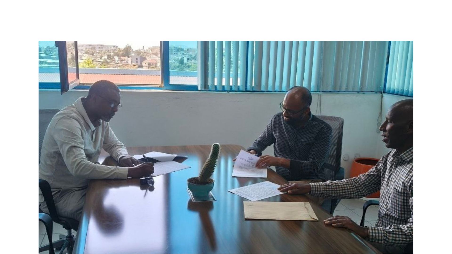 CESDA staff reviewing documents at a meeting