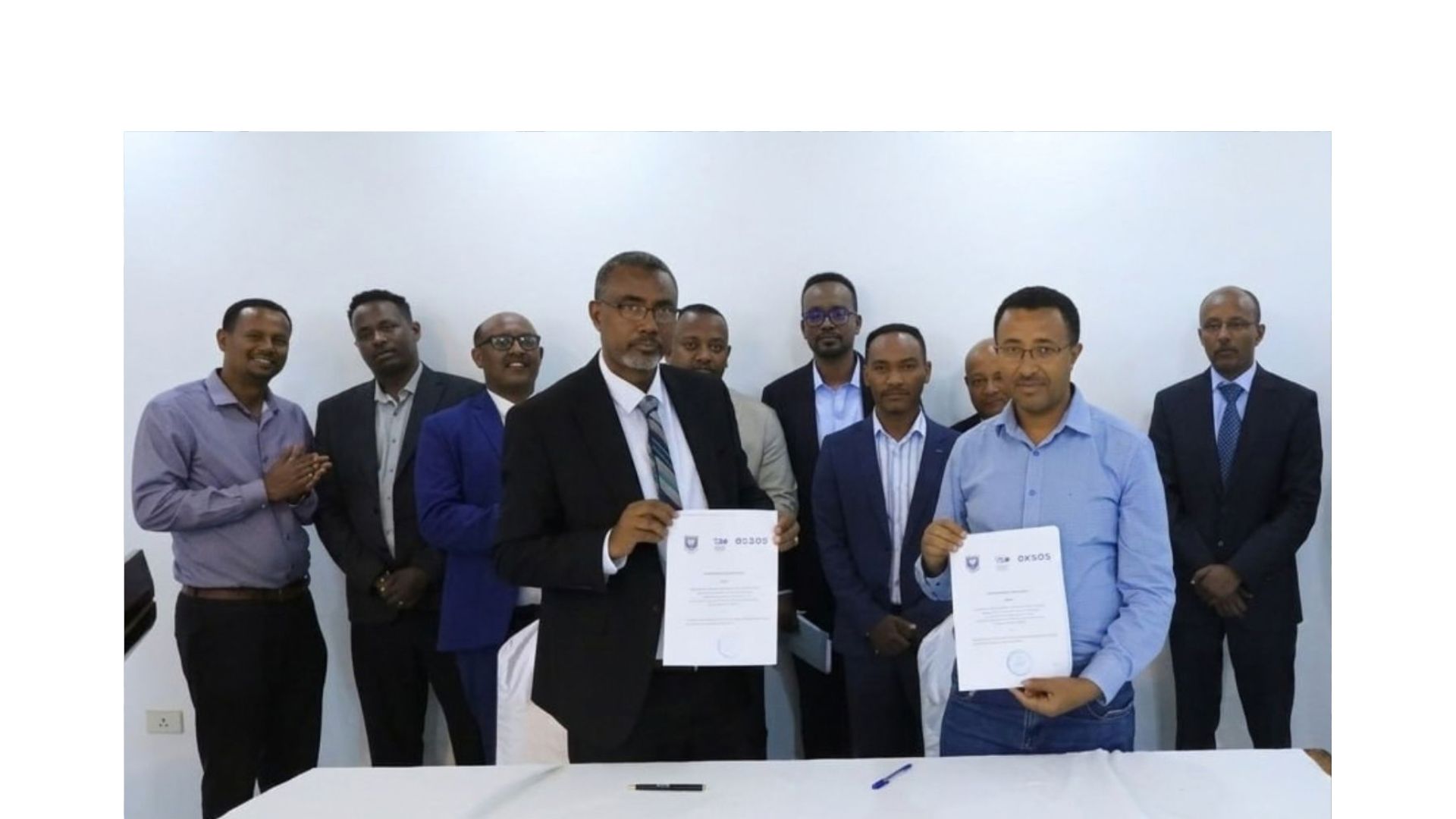 Partners holding signed agreements at a CESDA signing ceremony